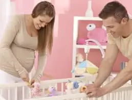 Mom and dad building a crib for the baby